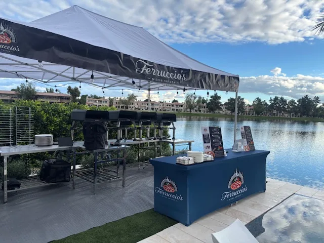 Ferruccio's tent and ovens set up beside a lake at a private Scottsdale event