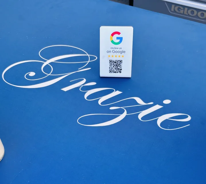 The Grazie table runner with a Google review card at a Ferruccio's event