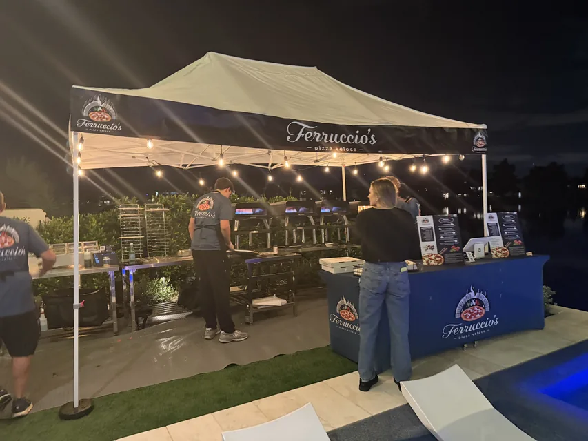 The Ferruccio's booth glowing at a nighttime public event