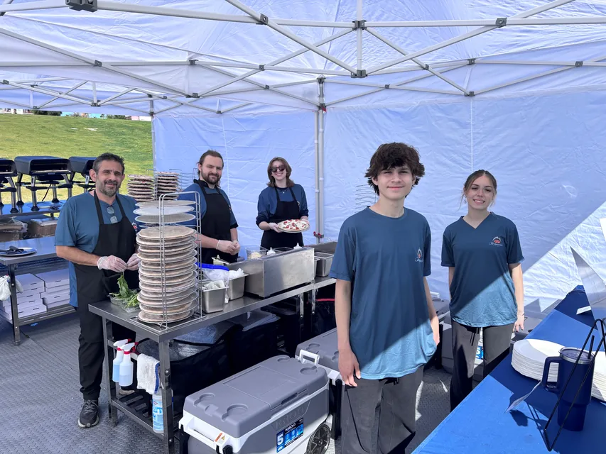 The Ferruccio's team smiling inside the tent before service